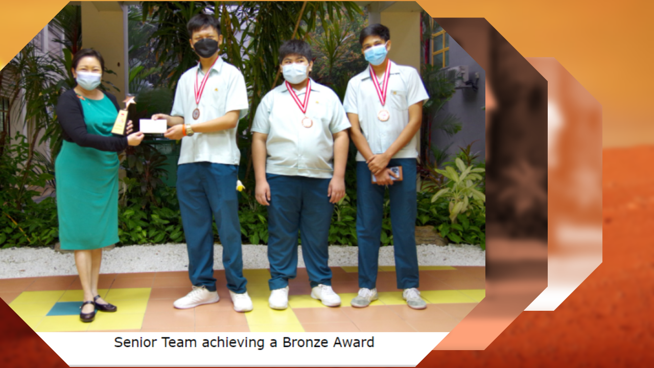 Photo of three Yio Chu Kang Secondary School students receiving a Bronze Award trophy and certificate.
